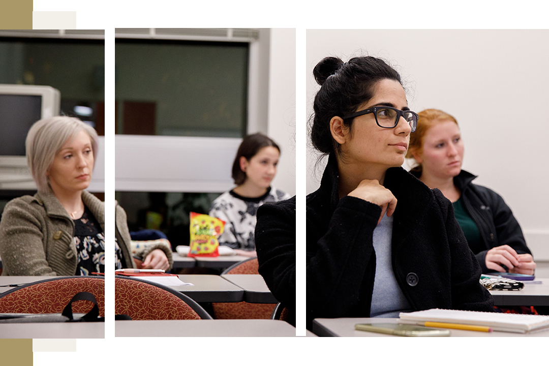 4 female students in publishing classroom listening attentively and looking forward