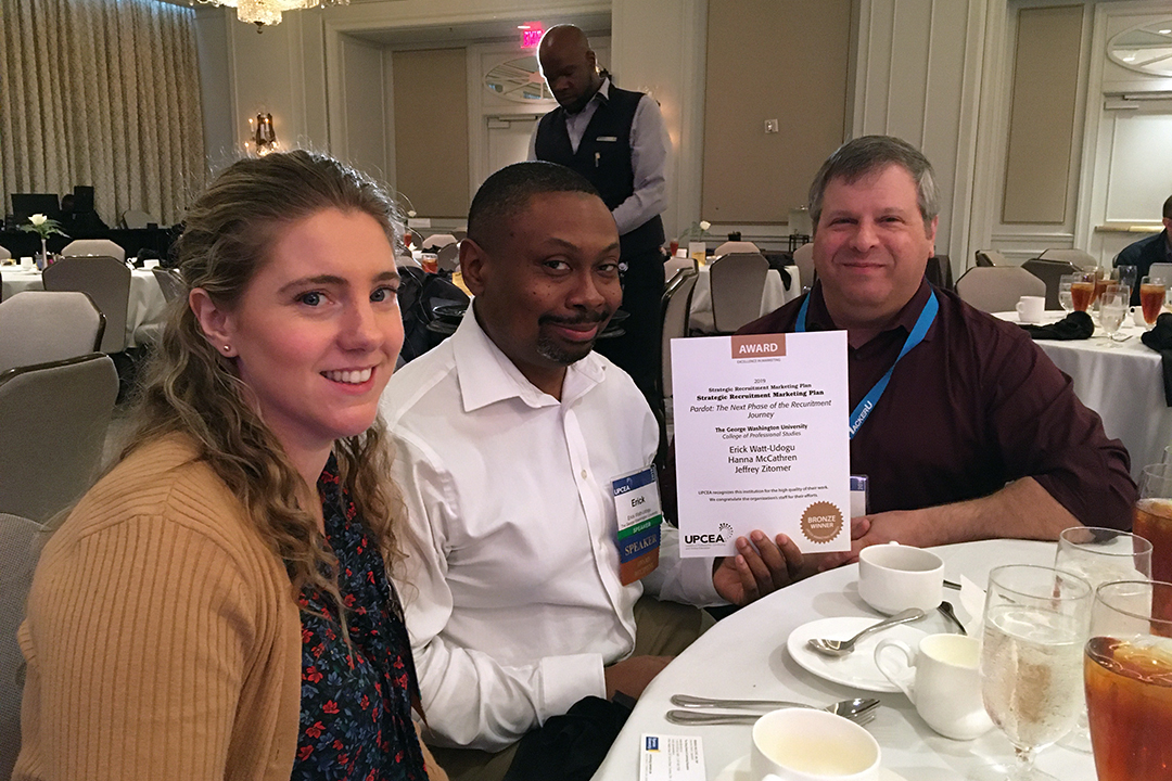CPS marketing team holding award certificate at lunch in ballroom