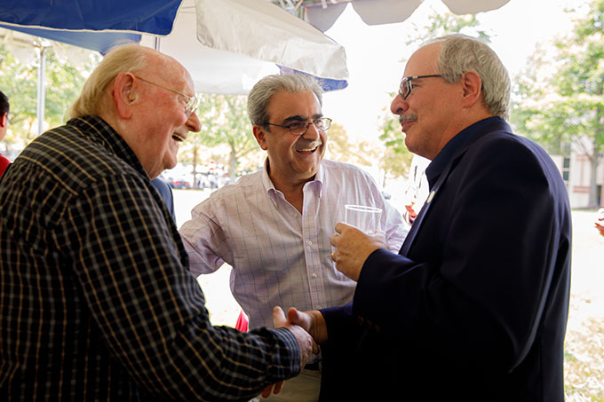 ​​Dean Eskandarian (center) introduces Terry Hufford, Professor Emeritus of Biology, to President LeBlanc (right). (William Atkins)