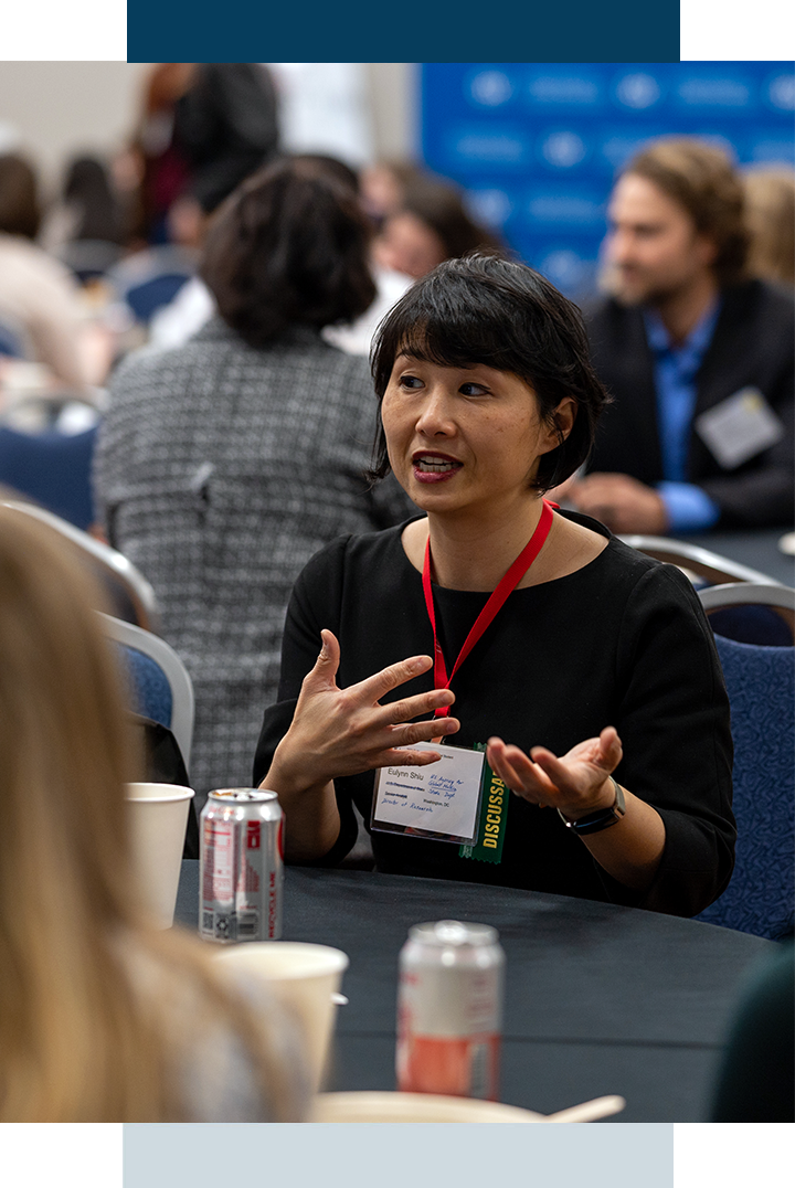 Students network at round table at an event