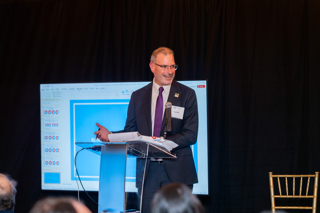 Todd Belt speaking onstage.