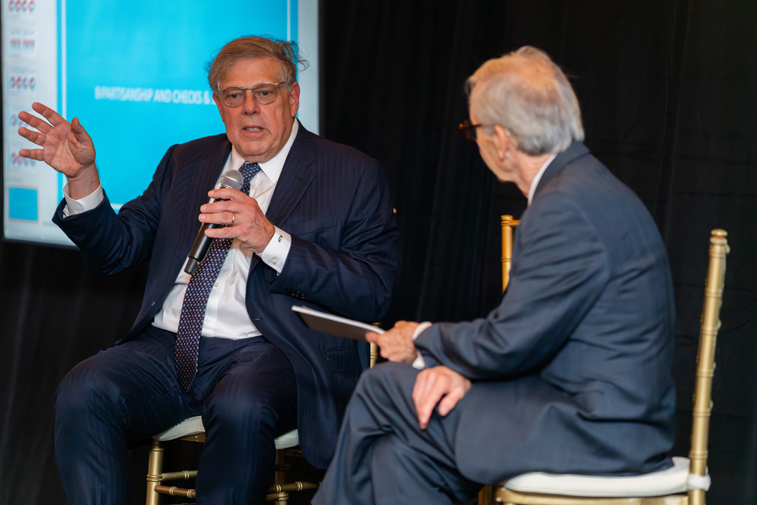 Chris Arterton and Mark Penn sitting onstage talking
