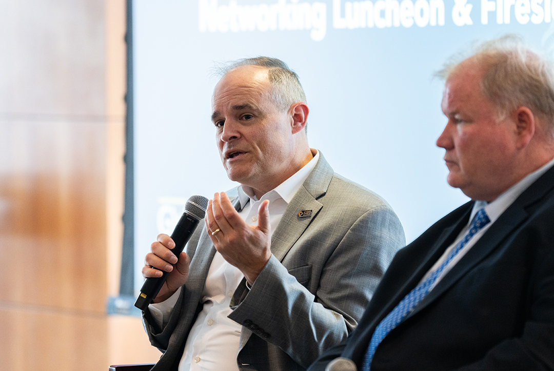 two men on cyber conference panel