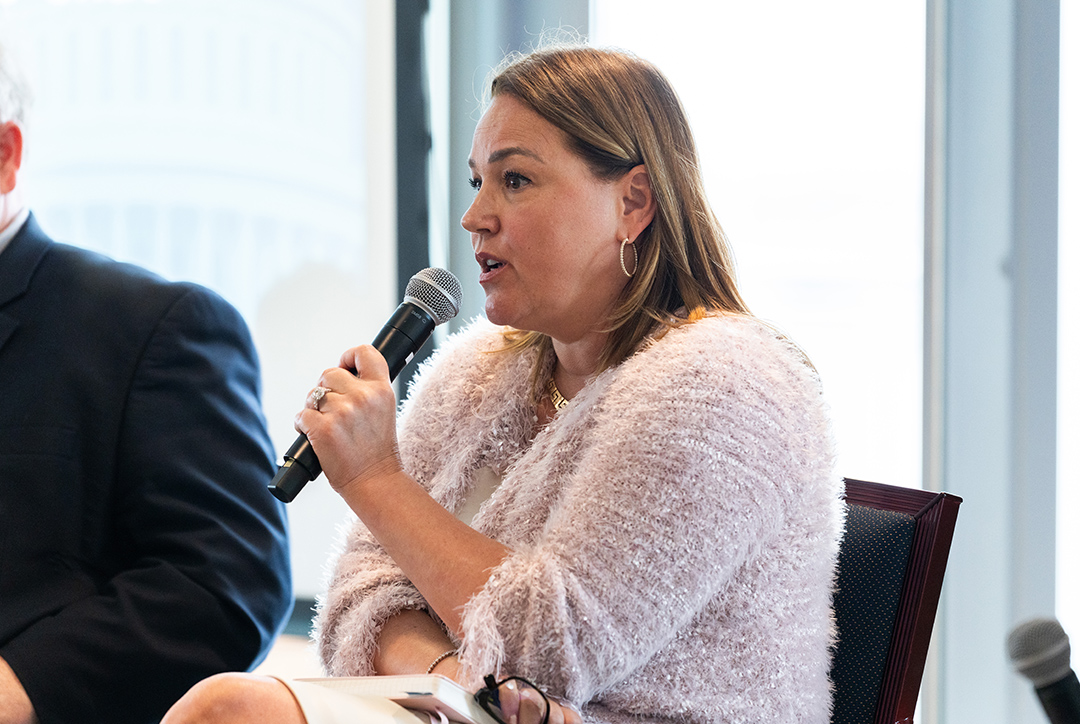 Woman with mic cyber conference 2025