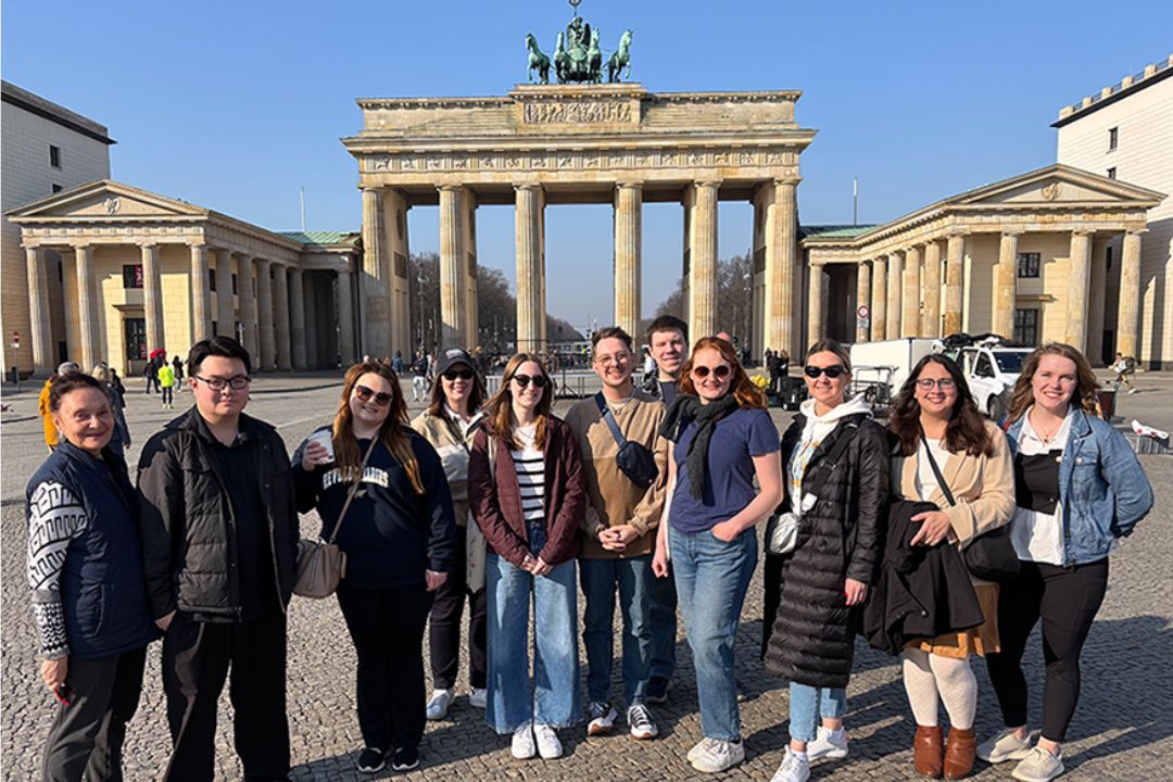 Students pose in front of the Brandenberg Gate in Berlin, Germany