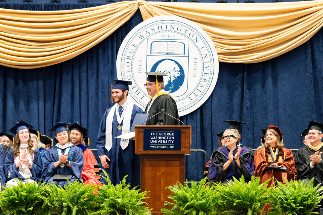 Jeff Delinski and Zachary T. Chnupa-Cox smile onstage together