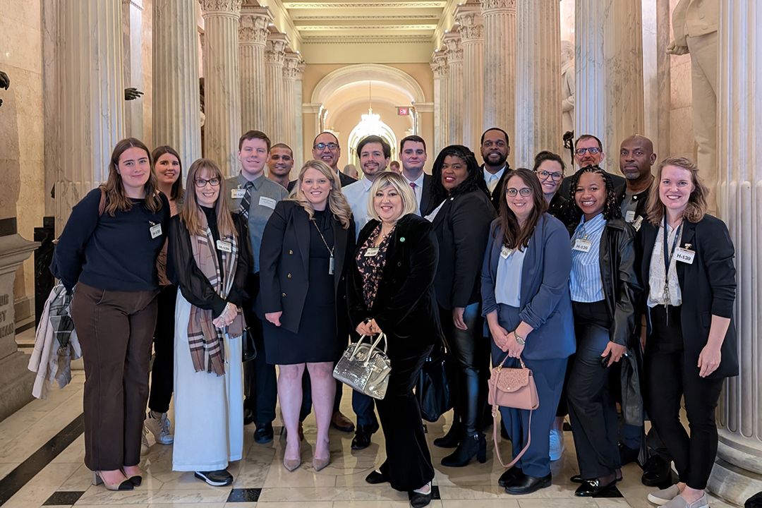 Group of GSPM students posing with Emily Berret in the U.S. Capitol Building