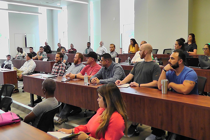 Graduate studentts listen to homeland security panel discussion