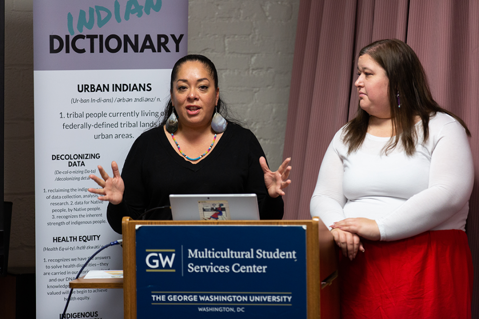 two women presenting report from the Urban Indian Health Institute at GW