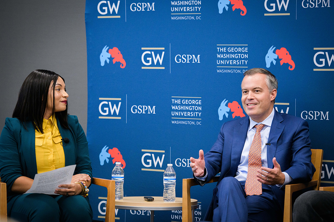 From left to right: Monique Chouraeshkenazi speaks with Matt Rhoades. 