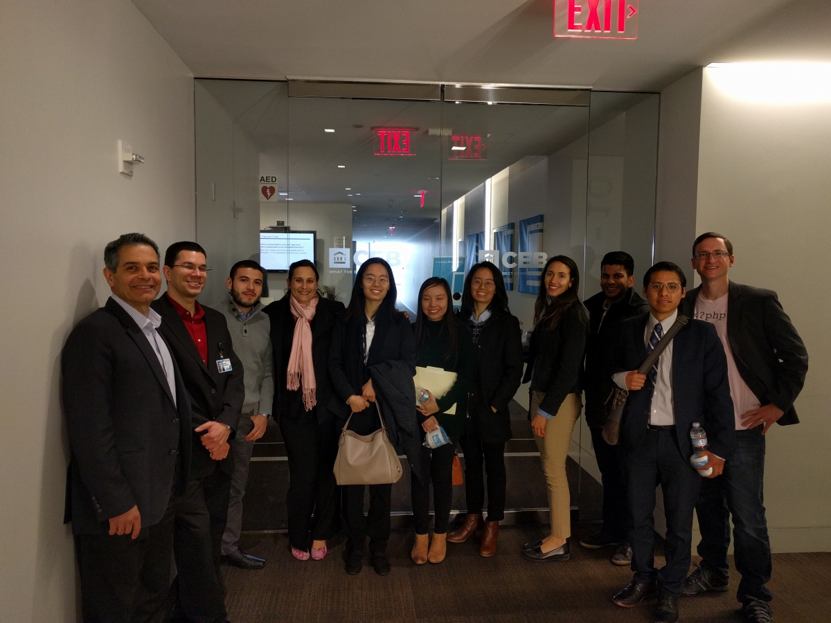 A dozen GW students during the site visit to the Corporate Executive Board posing in front of the building