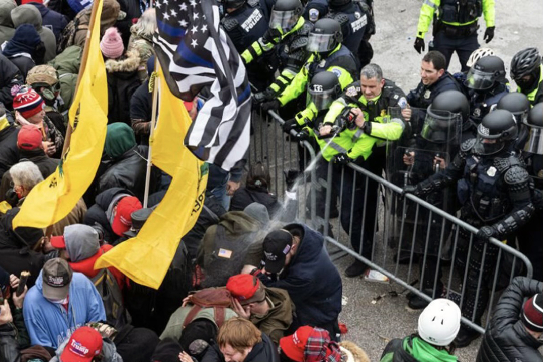 violent mob of people with barrier and police