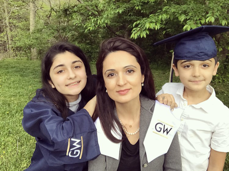 Mallaly Shpoon, Cybersecurity 2020 graduate with kids and son in cap and daughter in graduation gown