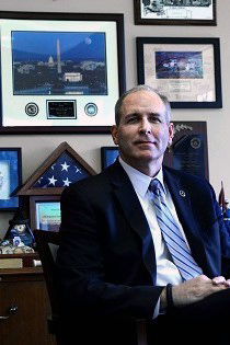 Mark Morgan in suit in office