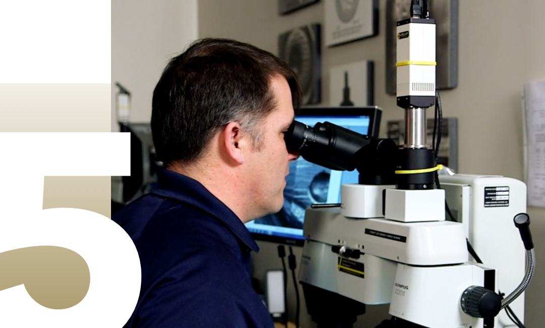 5; man looking in a microscope