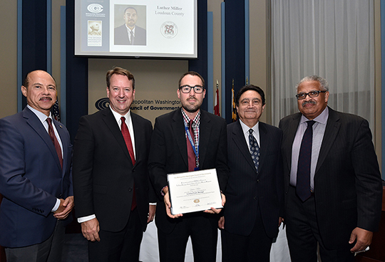 REDP graduate with officials at graduation