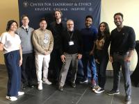 A group of people poses for a photo in front of a banner that reads "Center for leadership and ethics"