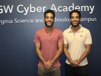 Twin brothers, students in front of GW Cyber Academy sign