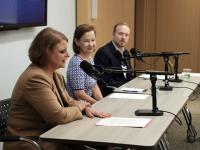 CPS Dean Riddle, Sharon McBride and Anthony Shop sitting at a table in front of microphones
