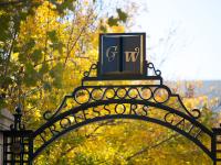 GW Professors Gate with fall leaves and trees