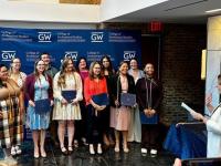 LEX inductees smiling and posing in front of step-and-repeat
