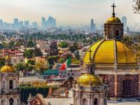 Basilica de Guadalupe exterior with the skyline of Mexico City in the background