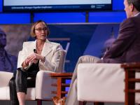 Amy Gilliland sitting onstage in conversation with Roger Cressey