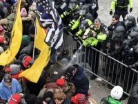 violent mob of people with barrier and police