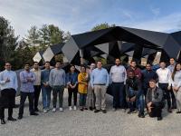 Large IIST student group of approximately 20 people in front of a black metal abstract sculpture