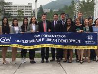 SUP student group with Program Director John Carruthers hold banner with words Sustainable Urban Planning Program, GW 