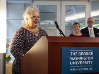 Susan Bro, mother of paralegal killed in protest, stands at podium and addresses attendees the celebration