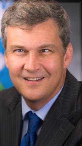 Photo of faculty member Dr. John Thomas in professional attire