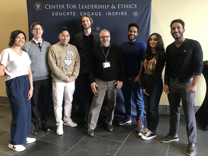 A group of people poses for a photo in front of a banner that reads "Center for leadership and ethics"