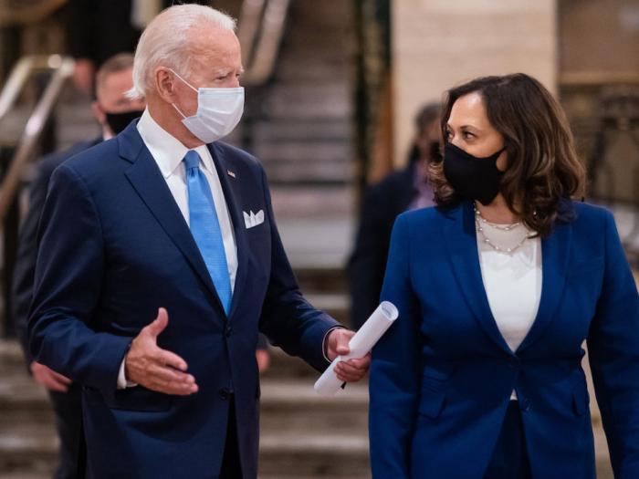 Joe Biden and Kamala Harris, both wearing blue suits and face masks