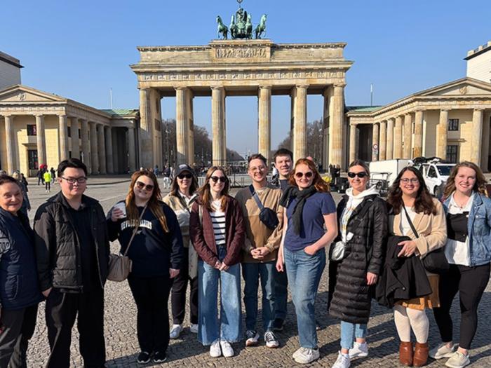 Students pose in front of the Brandenberg Gate in Berlin, Germany