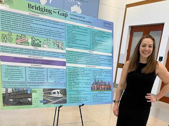 Female student with her capstone research poster