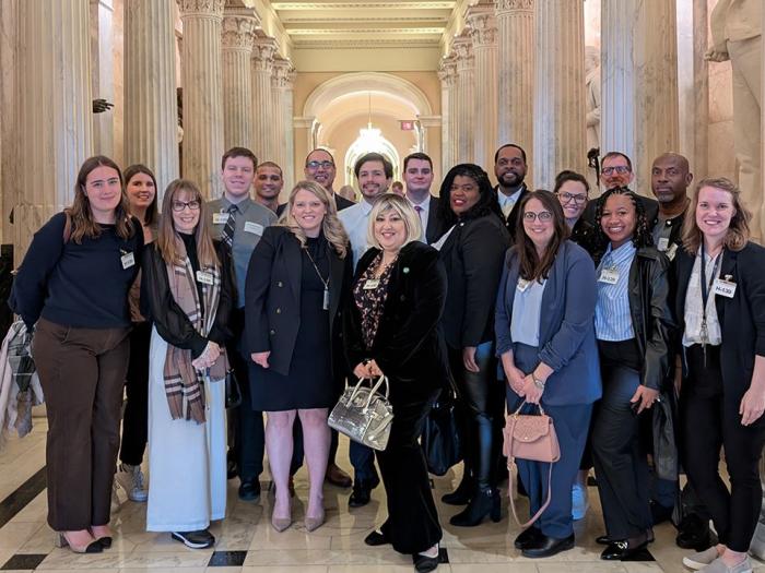 Group of GSPM students posing with Emily Berret in the U.S. Capitol Building