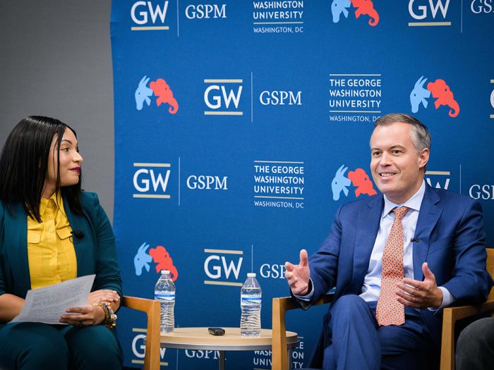 From left to right: Monique Chouraeshkenazi speaks with Matt Rhoades. 