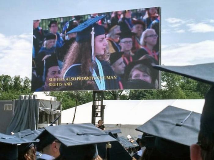 graduation ceremony with cap and gowns
