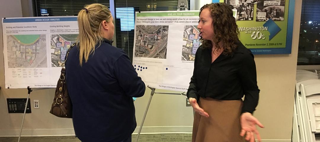 Amanda Esposito talks with a Shirlington resident at the open house in November 2019.