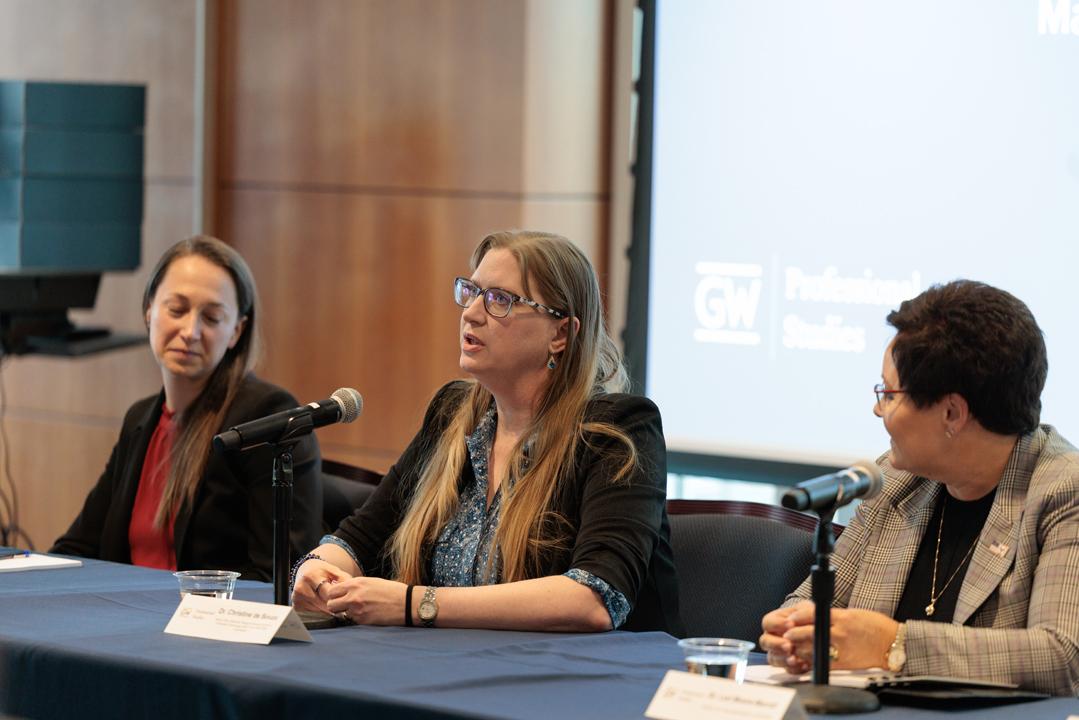 Katelyn Semales, Dr. Christine de Souza and Dr. Lori Moore-Merrell sitting at a panel with microphones