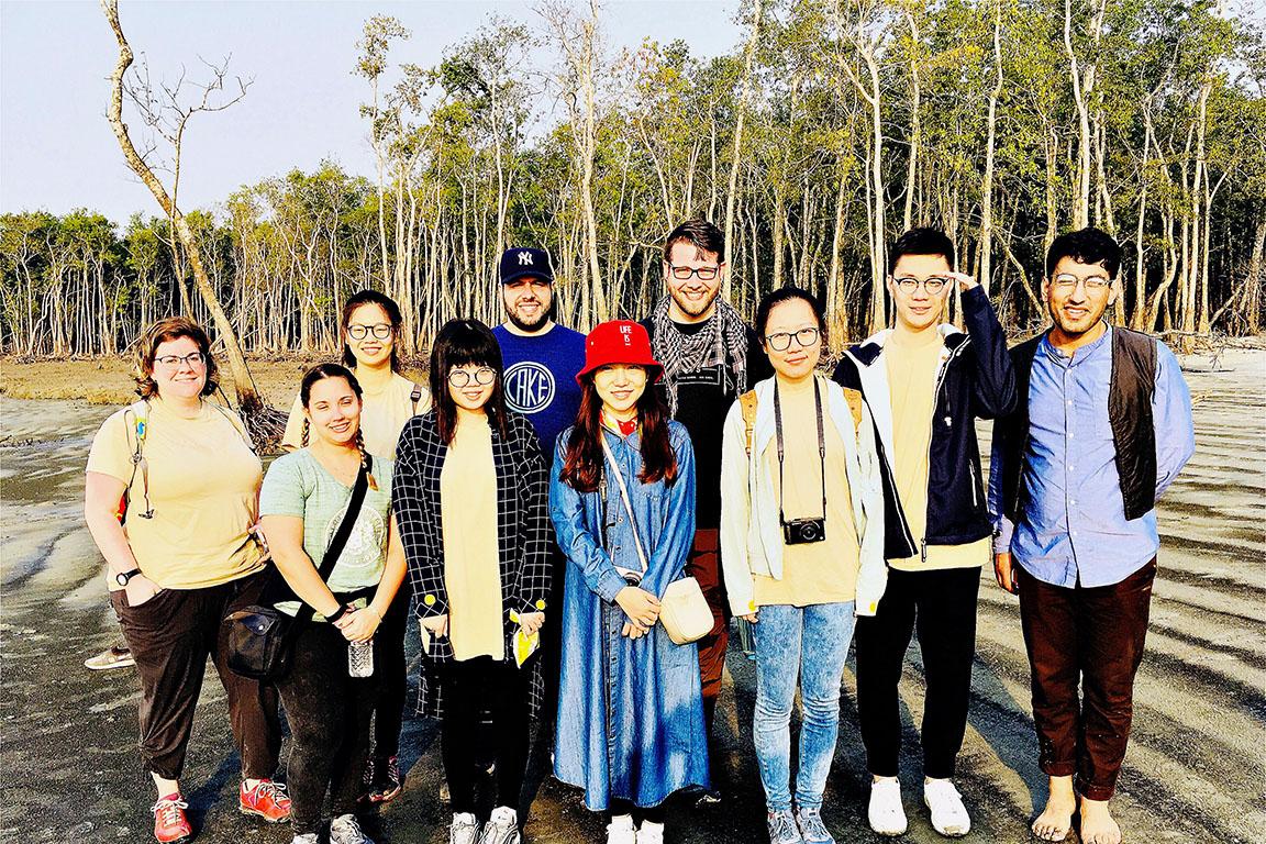 SUP student group on beach with trees