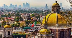 Basilica de Guadalupe exterior with the skyline of Mexico City in the background