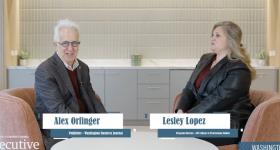 Alex Orfinger and Lesley Lopez sitting in chairs opposite one another